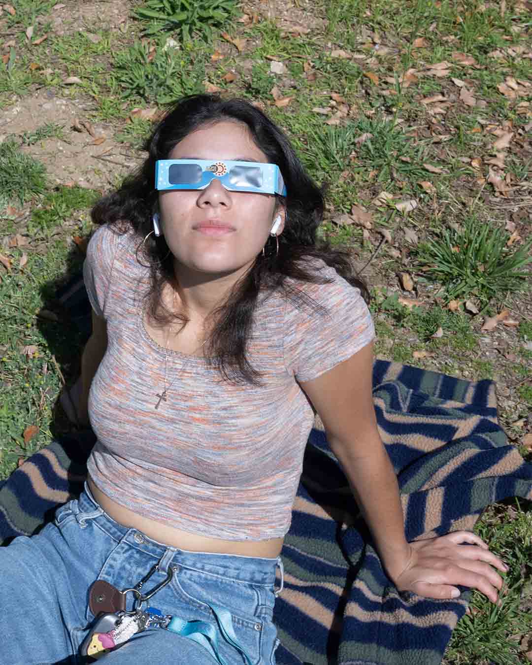 Student looks up wearing solar glasses