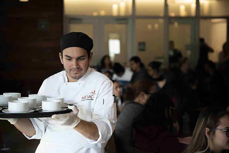 Students chefs serve the meal they made