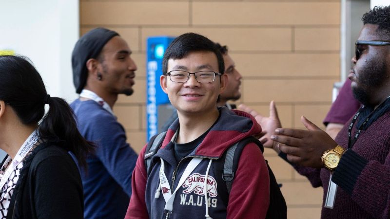 student smiling at conference