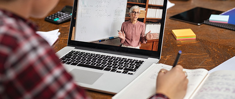 Student watches professor on laptop