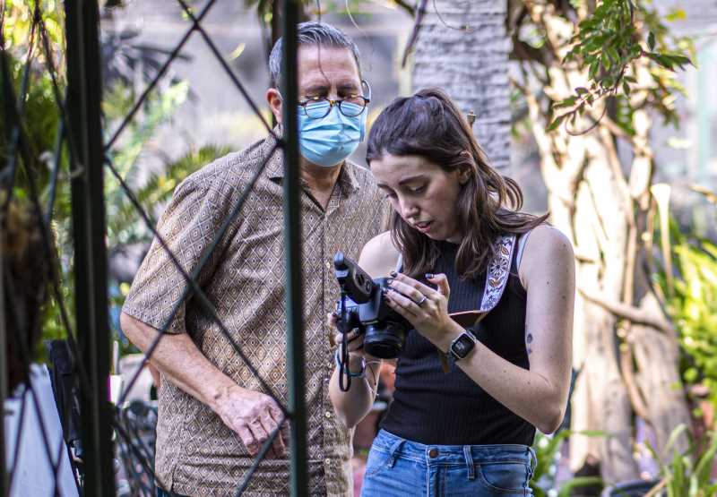 Photography Club student Ashley Walsh reviews her shots with Professor Jay P. Morgan looking on