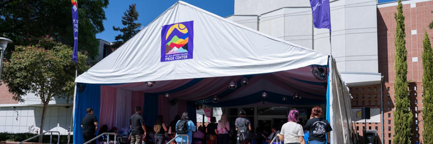 Pride 10th Anniversary Event held in rainbow-colored tent.