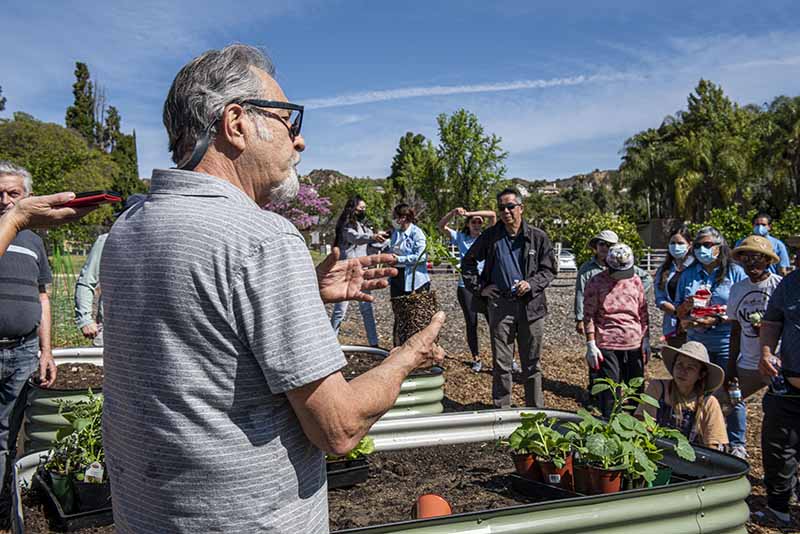 Professor instructs at REACH garden opening