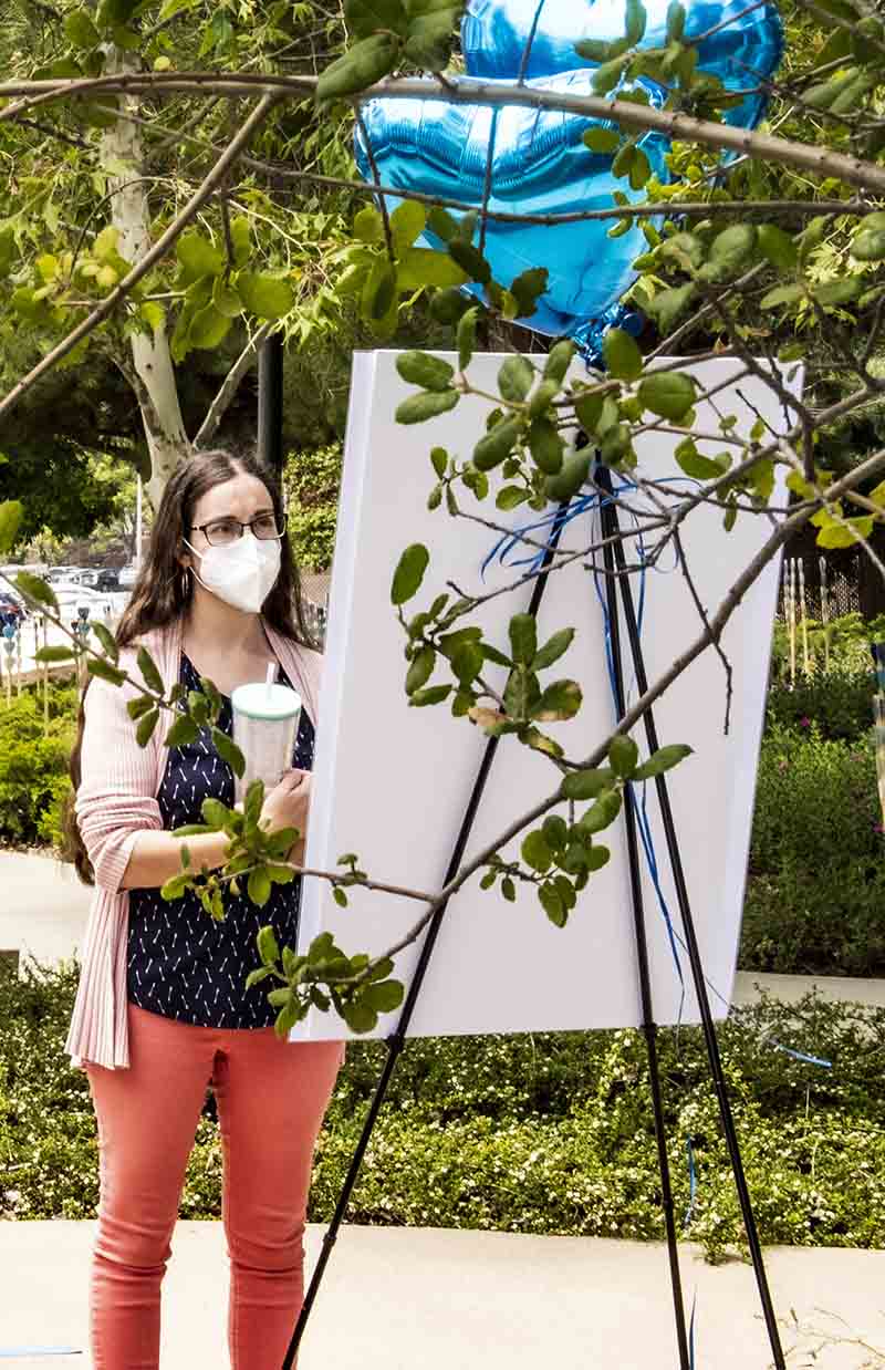 student with REACH Interpretive sign