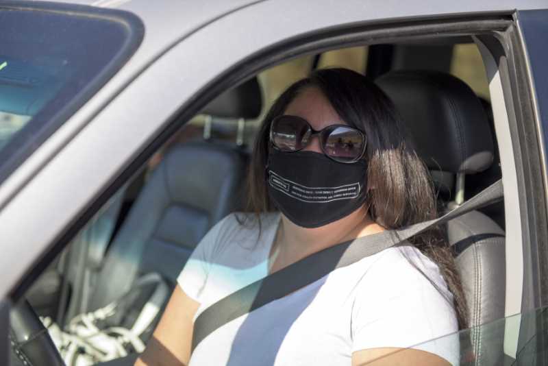 Student Meg uses the safe drive thru procedure to pick up a thanksgiving dinner