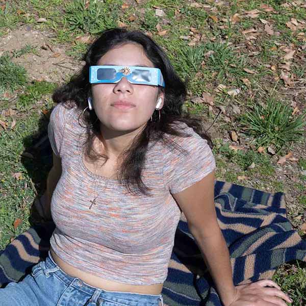 Student looks up wear solar glasses