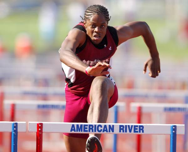 Track athlete jumps hurdle