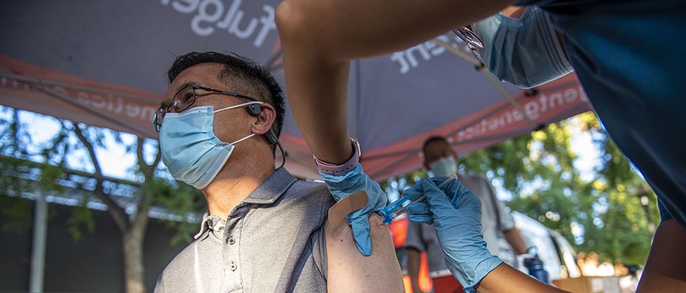 Man get vaccine booster from nurse