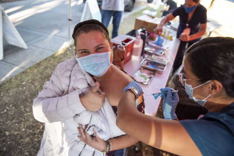 Woman gets vaccine shot from nurse