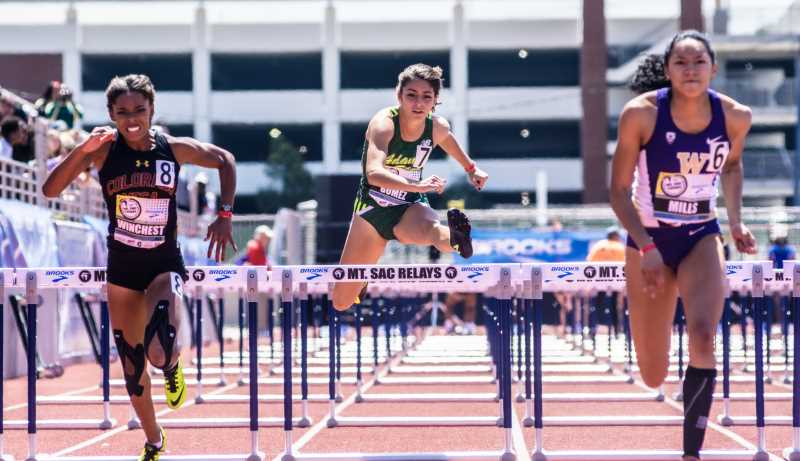 Female competitors jump over hurdles - courtesy of Mt. SAC Relays Photographer