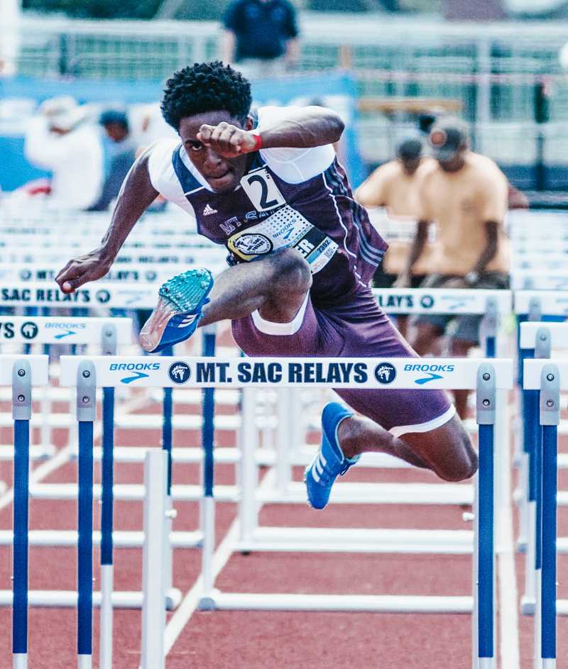 Male Mountie hurdle runner launches - courtesy of Mt. SAC Relays Photographer 