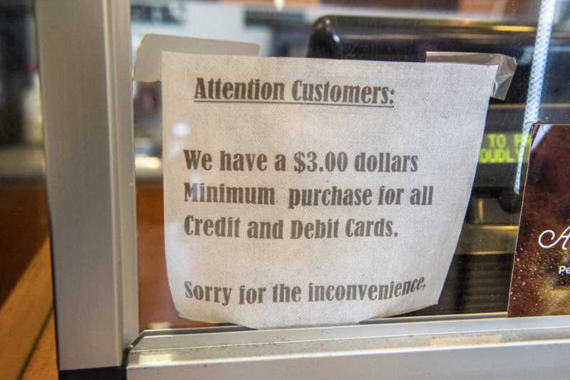 sign says "WE have a $3.00 minimum purchase for all credit and debit cards."
