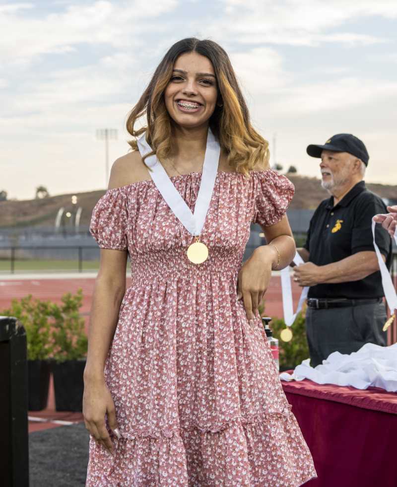 Student smiles with her medallion