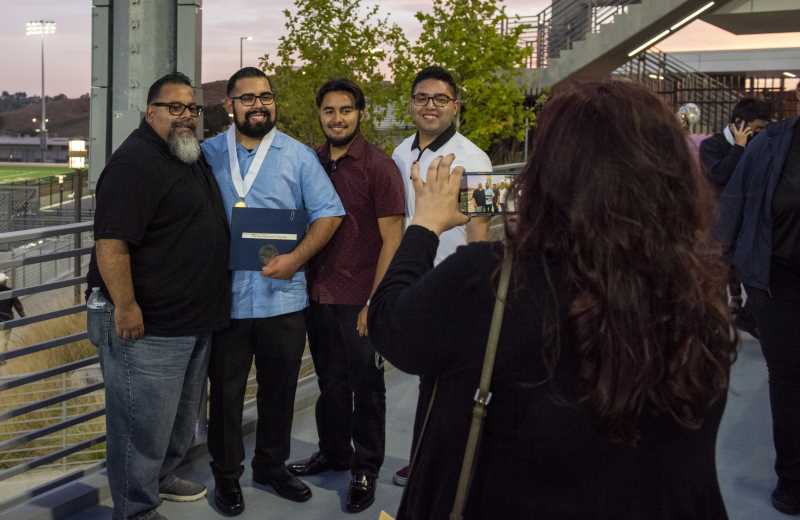 Student poses with his family