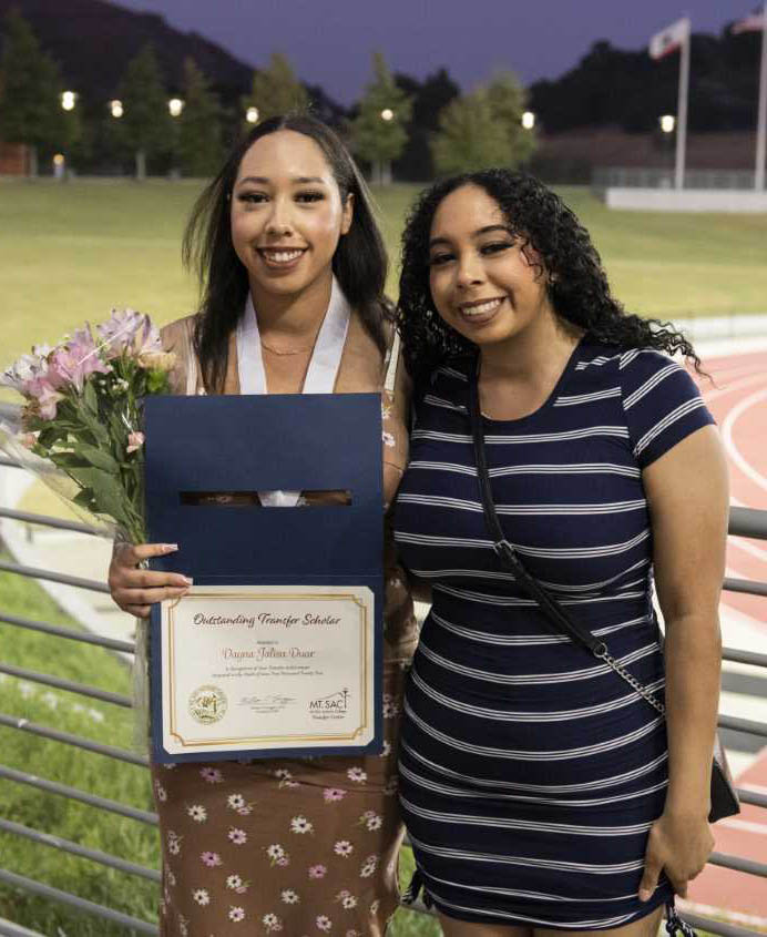 Student and her family member pose with her certificate