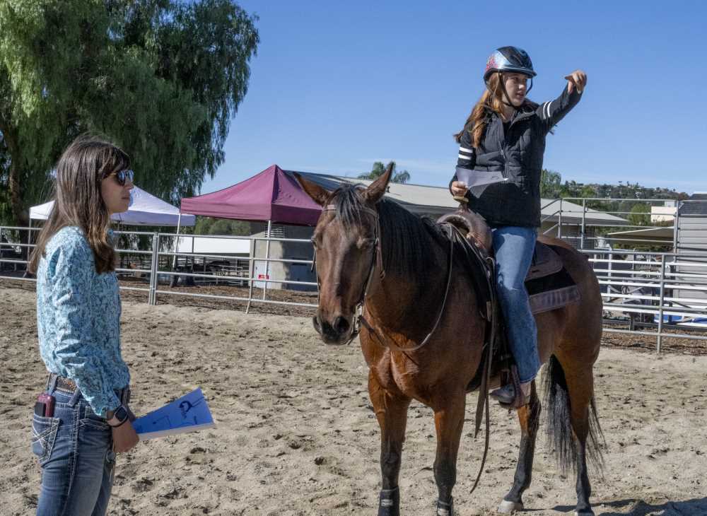 Brooklyn (L) points the route of a drill while Sara looks on