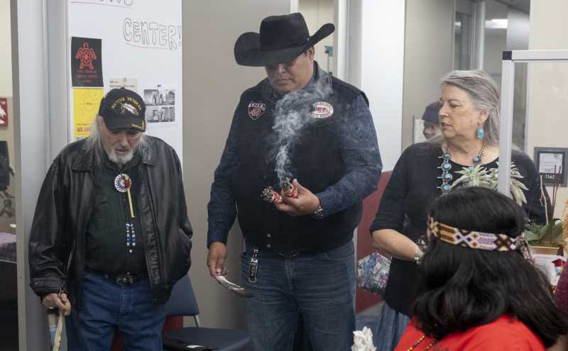 (L to R) Robertjohn Knapp, Jayson Brave Heart smudging sage, and Dr. Frances Borella