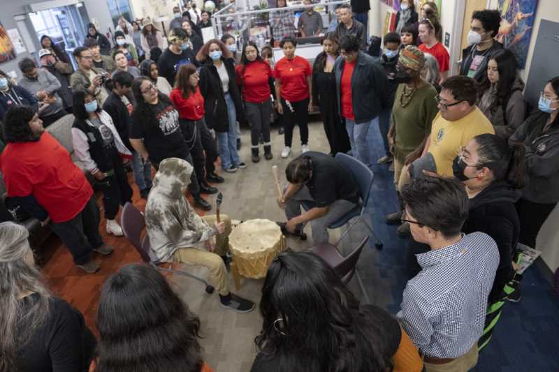 attendees dance around drummers