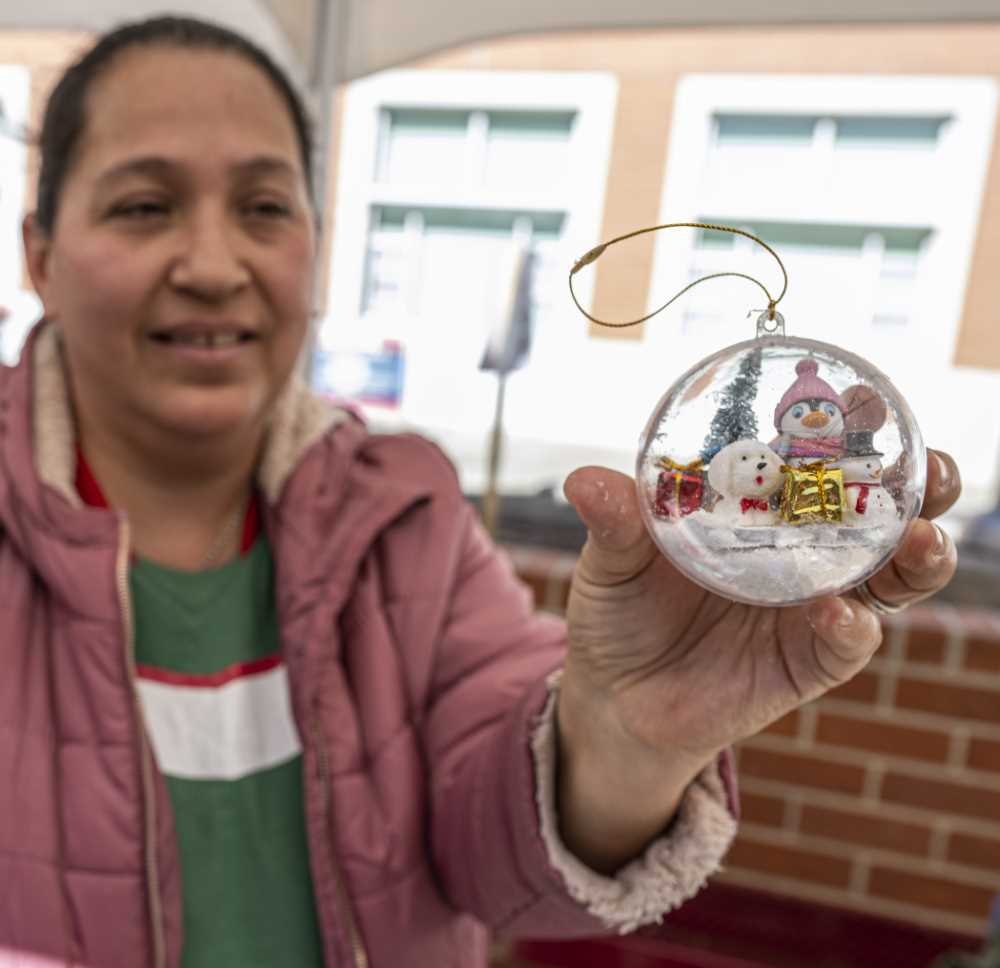 Woman holds ornemnt she made