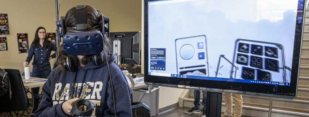 Student with VR headset plays game