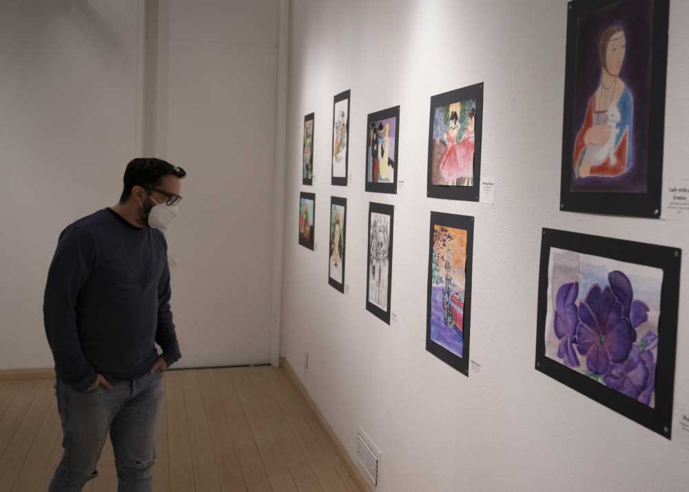 Art professor Jason Ramos looks at the exhibit