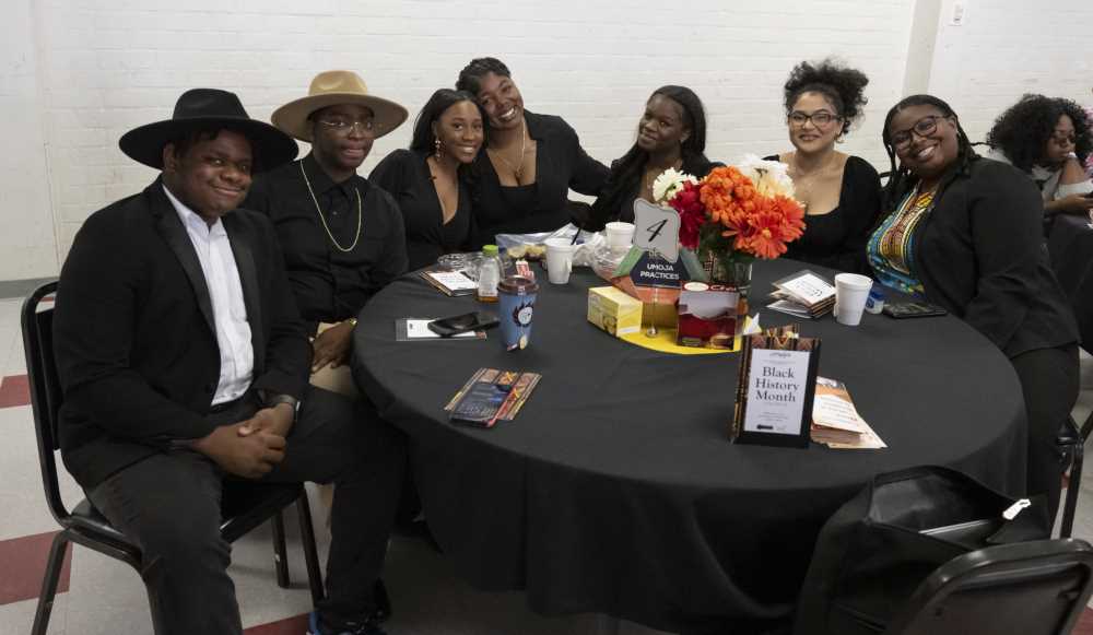 The Center Singers student group at table