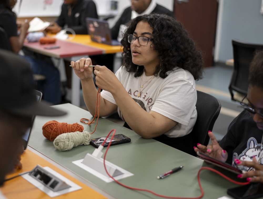 Student does some knitting at The Center