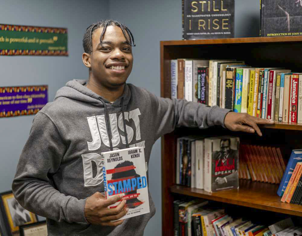 Jalen Lattimore holds book "Stamped"