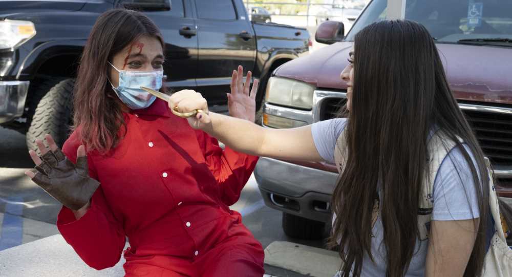 Students dressed as killer and her victim