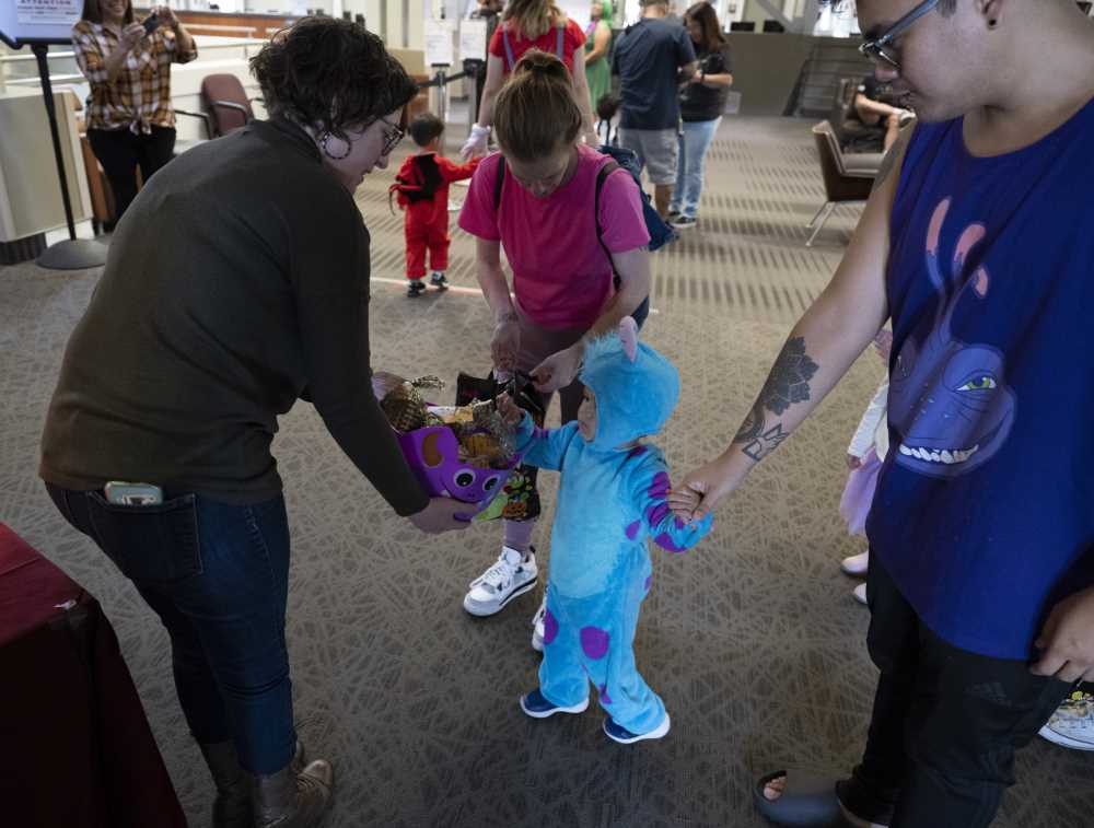 Staff hands out candy to kids