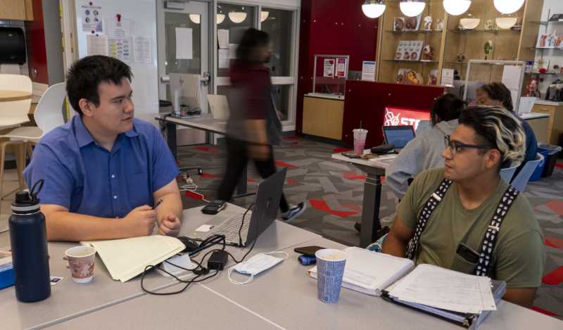 Shao-wen Larios (left) studies with a friend.  