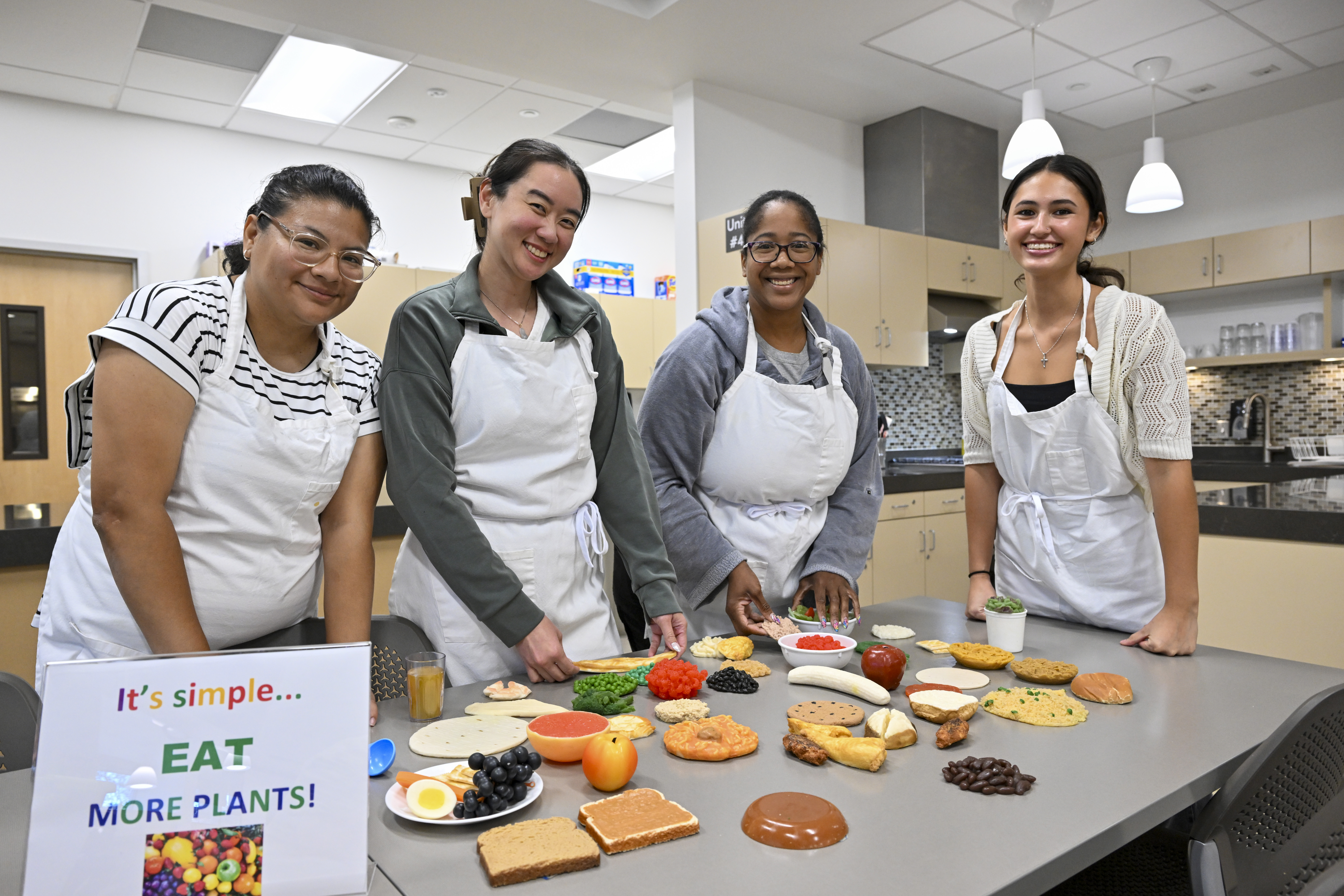 students in classroom smiling the nutritional items on the table