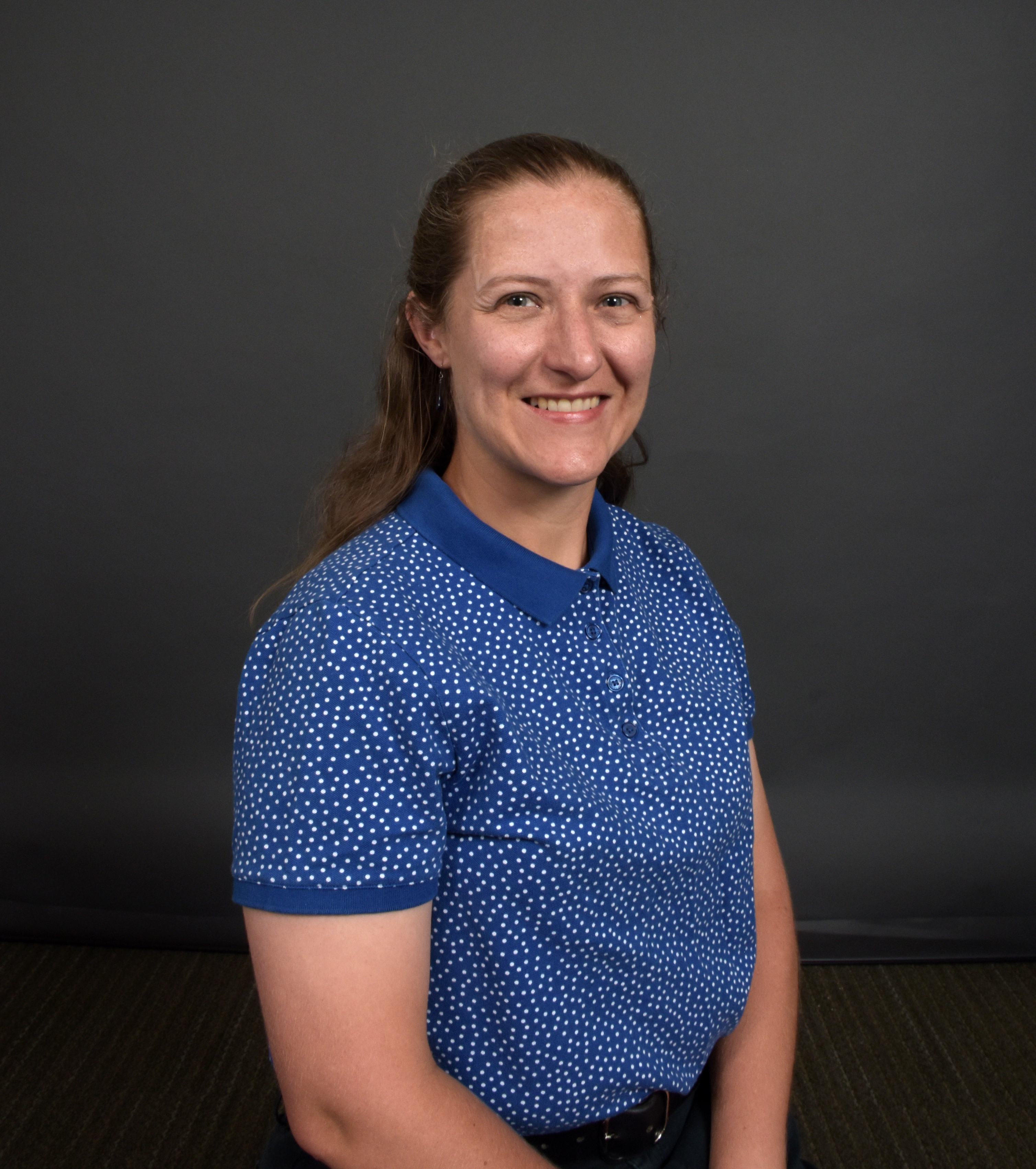 Sarah Nichols smiling, wearing a blue shirt