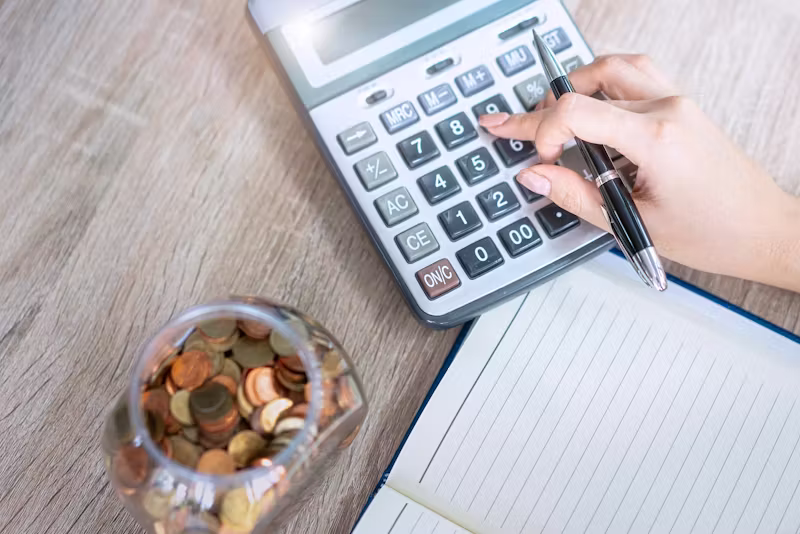 hand with pencil and calculator