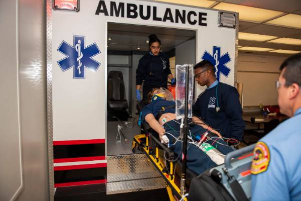 emt students practice in ambulance